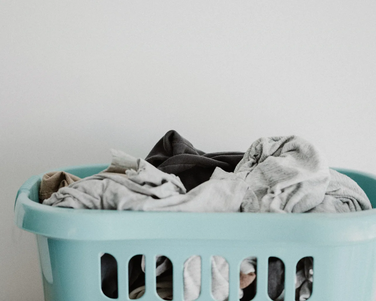 Neat pile of freshly folded laundry in a basket, ready for delivery by Eudemonia in Richardson, TX